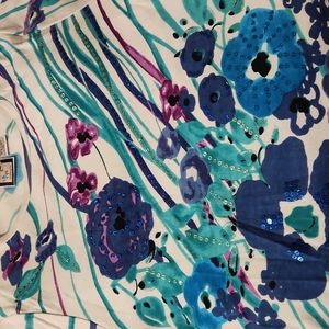 Dressy tee with sequins throughout front.